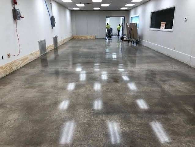 Commercial concrete polishing job in progress in a large space