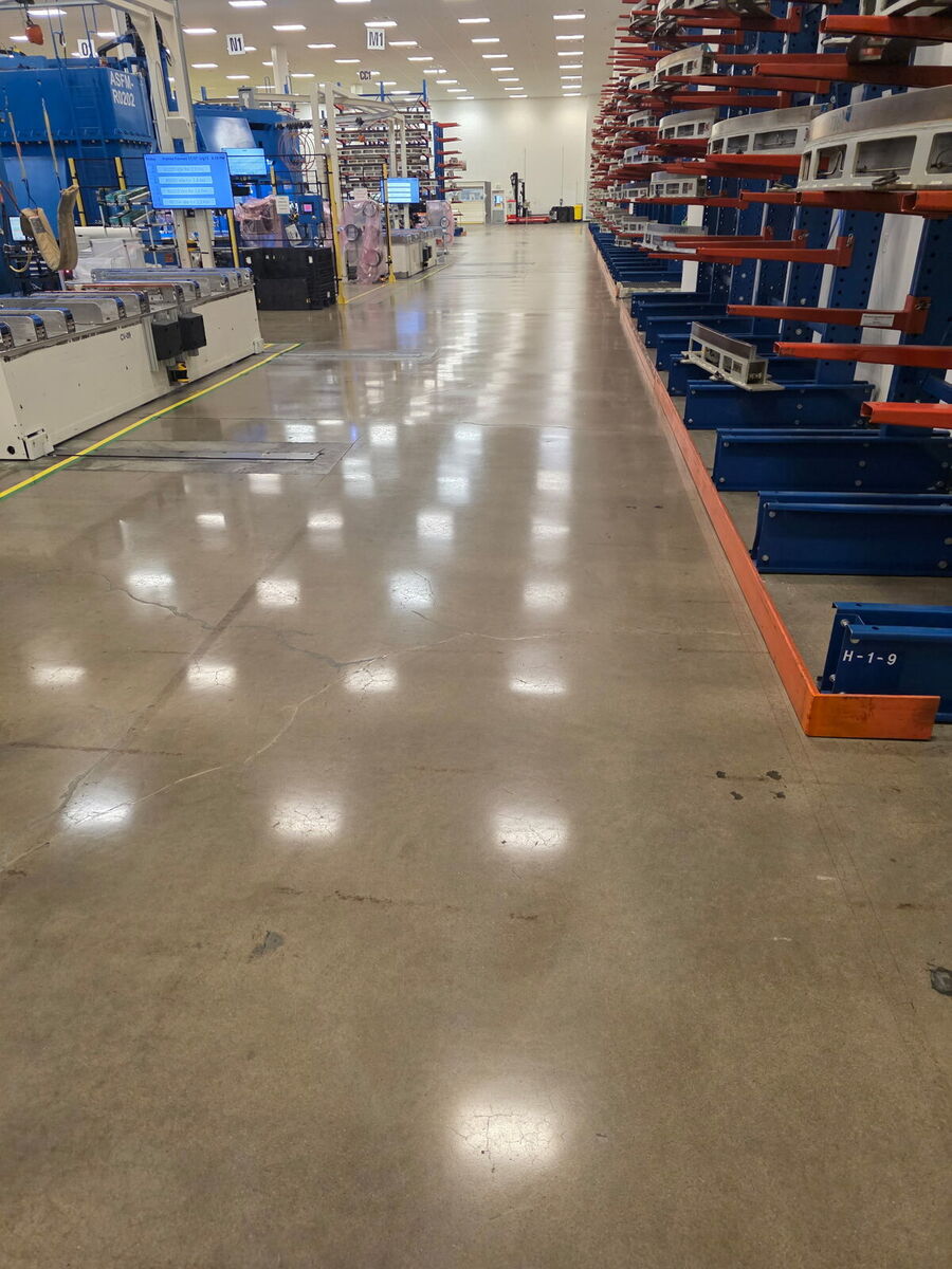 Polished concrete aisle in a manufacturing facility with cantilever racking