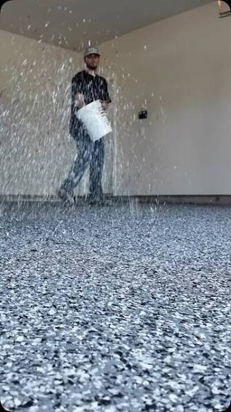 Professional installer working on an epoxy garage floor